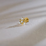 Traditional gold nose pin with floral diamond design on soft background