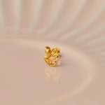Gold stud earring with bird and flowing feather design