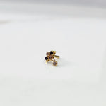 Antique-style gold ring with blue-toned stones in branch pattern, angled view