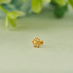 Gold flower-shaped stud earring with textured petal design