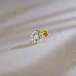 Round halo lab grown gold nose pin with center diamond on soft background