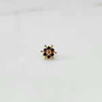 Close-up of gold statement ring with multicolor gemstones in scattered dotted cluster design