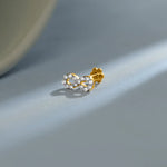 New nose pin design gold with elegant twin floral stone pattern set in a polished gold base on a soft pastel background