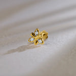 Flower-shaped stud earring with sculpted gold petals and small diamond accents
