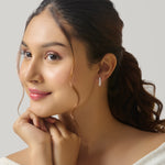 Close-up of woman wearing gold bar stud earring
