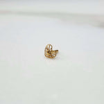 Front view of a tiny 18K nose pin gold placed on a white background showing its small size and fine detailing