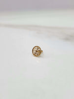 Side view of a delicate 18K nose pin gold on a light background showing its fine finish and minimal design