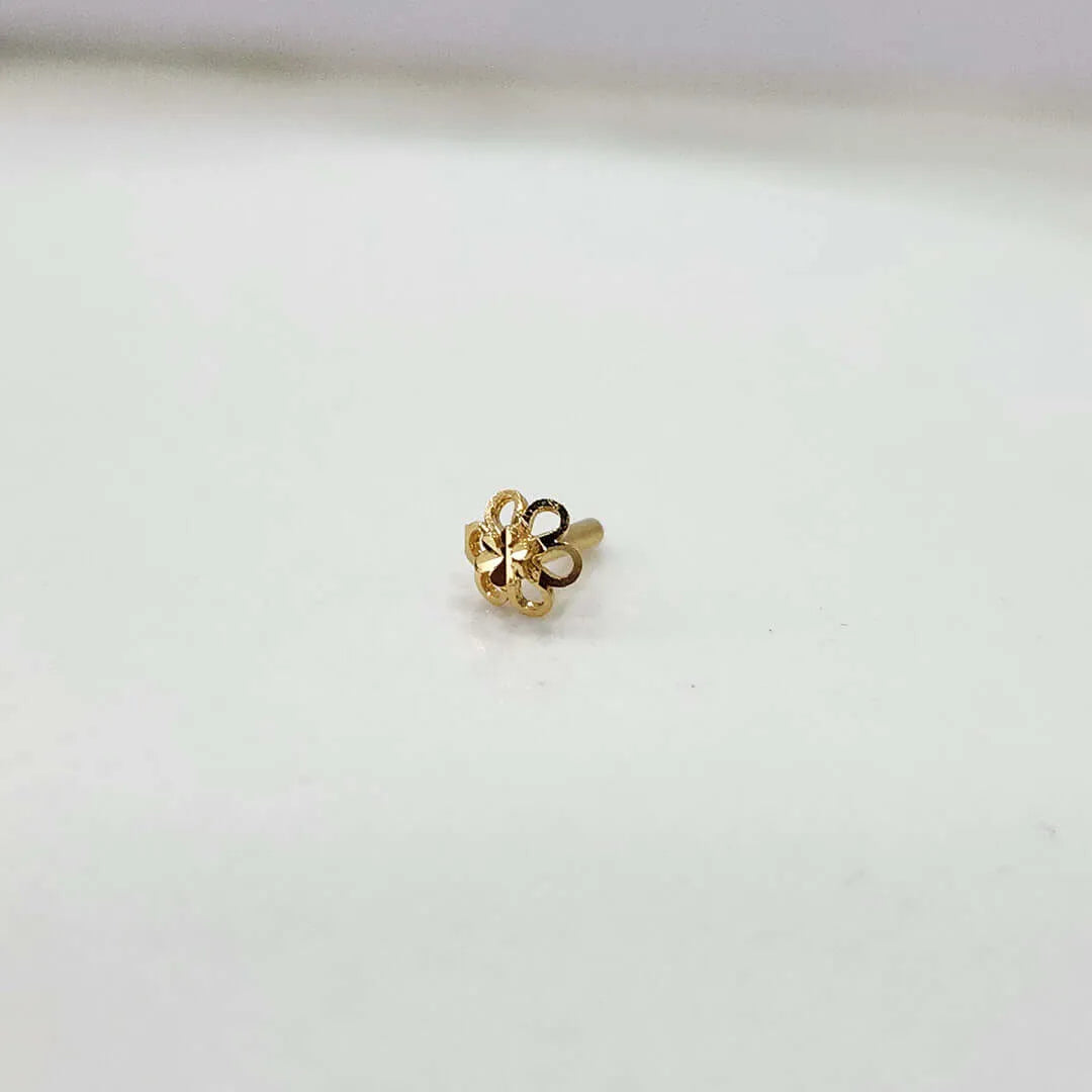 Front view of floral gold nose pin on a white background showing its compact size and detailing