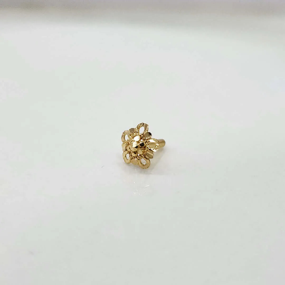 Front view of small floral gold nose pin on a white background showing its compact size and fine craftsmanship