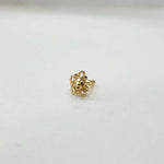 Front view of small floral gold nose pin on a white background showing its compact size and fine craftsmanship