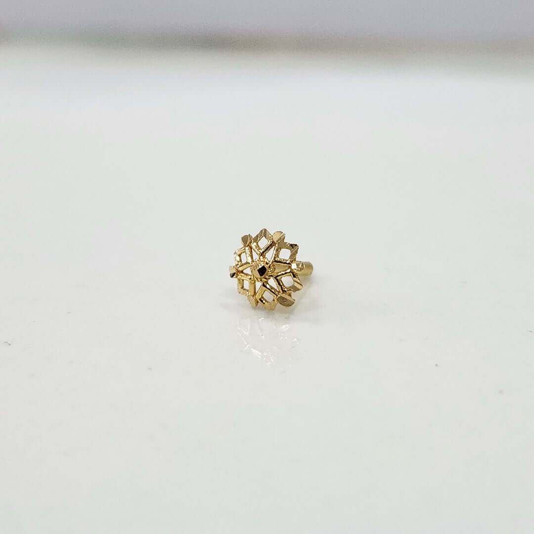 Front view of floral gold nose pin on a white background showing compact size and neat detailing