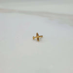 Side view of a small 18K gold nose pin placed on a white background showing its compact size and simple design