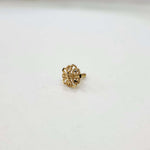 Front view of small floral gold nose pin on a white background displaying its compact size and intricate design