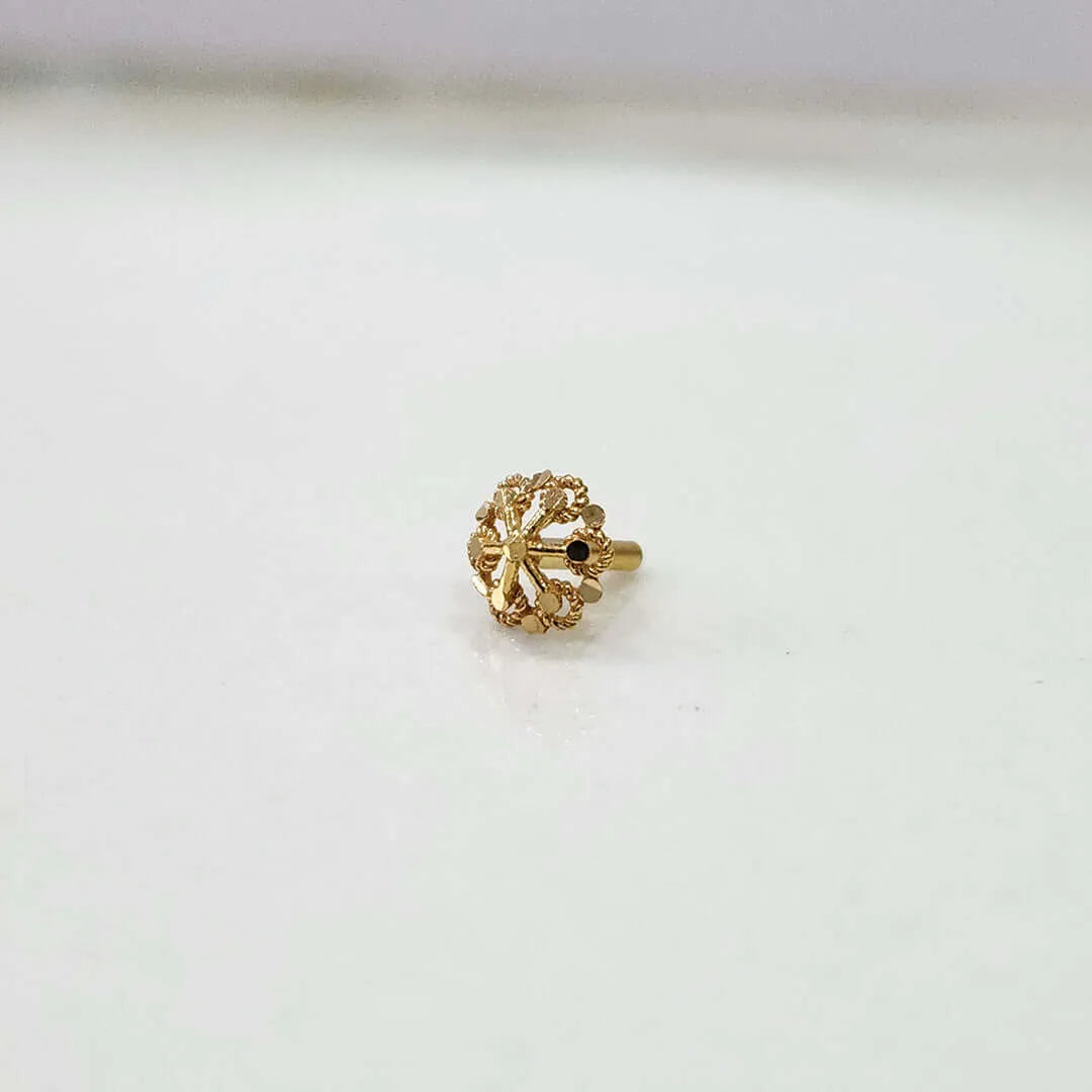 Front view of floral gold nose pin on a white background displaying its small size and fine detailing
