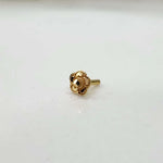 Front view of a floral gold nose pin on a clean white background showcasing its size and detailed craftsmanship