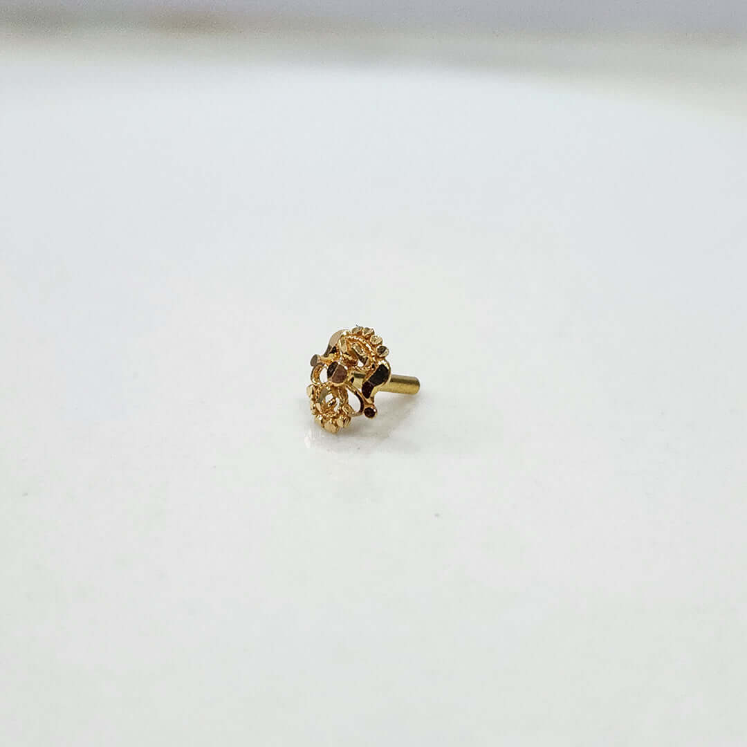 Side angle of the gold nose pin on a white background showing subtle detailing and smooth finish