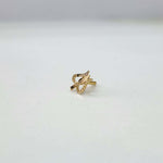 Close-up view of an elegant 18K gold twisted nose pin placed on a white background showcasing its sleek, modern design