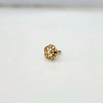 Front view of tiny floral 18K nose pin gold placed on a white surface highlighting its fine detailing