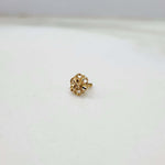 Front view of tiny floral 18K nose pin gold placed on a white background highlighting its delicate detailing