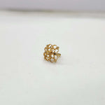 Front view of tiny lattice-pattern 18K nose pin gold placed on a soft white background highlighting its fine detailing