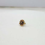 Slight angle view of the floral gold nose pin highlighting stone setting and design depthsurface