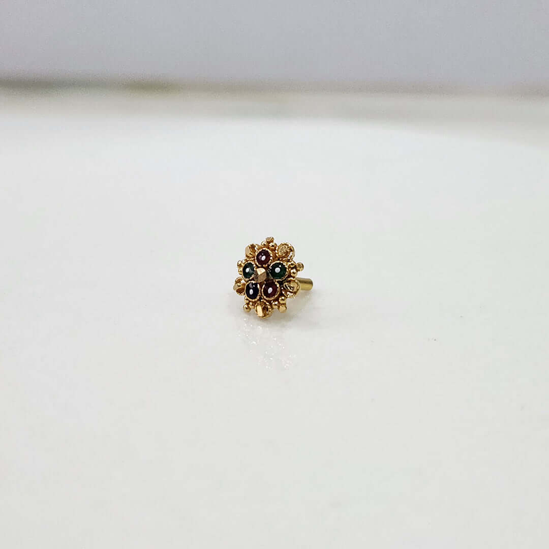 Slight angle view of the floral gold nose pin highlighting stone setting and design depthsurface