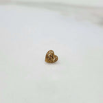 Front view of a small heart design gold nose pin placed on a white background showing compact size