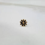 Angled view of the daisy motif gold nose pin on a white background emphasizing depth and craftsmanship