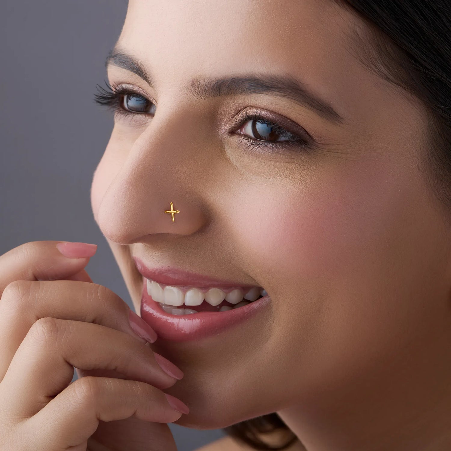 Woman wearing a minimalist cross design gold nose pin showcasing a modern everyday look