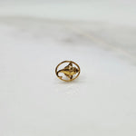 Close up of handcrafted floral gold nose pin design on white background ideal for elegant daily wear