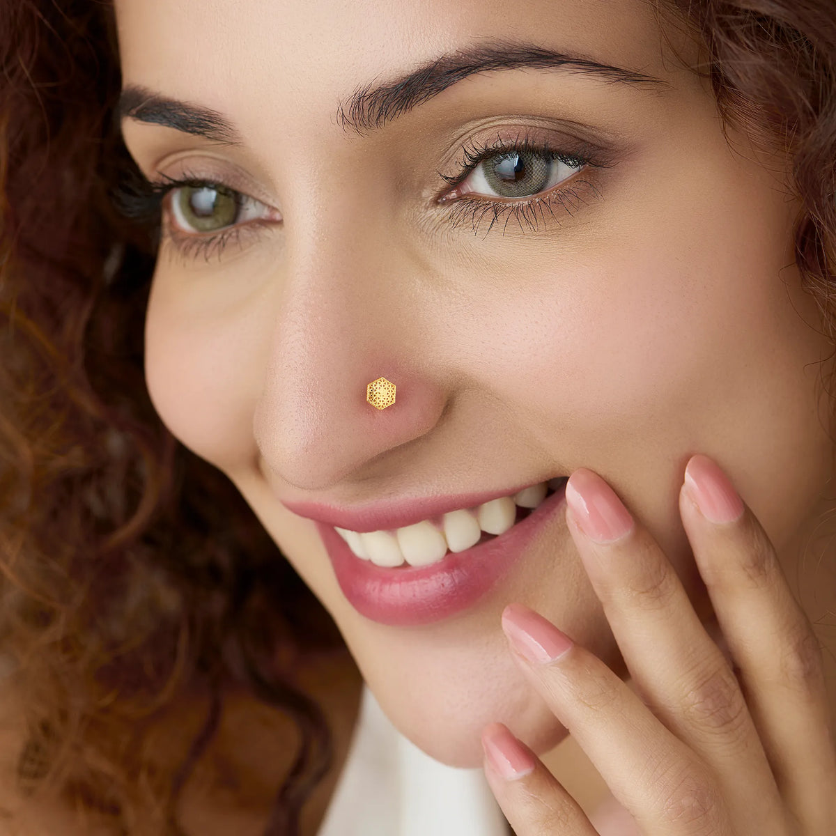 Front view of geometric hexagon cutwork 18K gold nose pin on a white background highlighting intricate pattern detailing