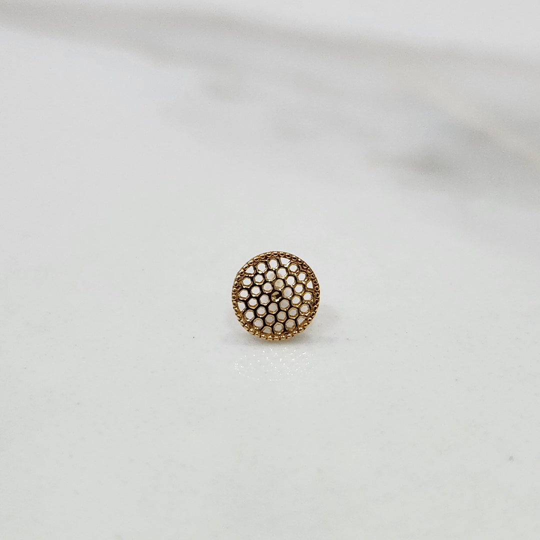 Close up of round geometric gold nose pin design on white background elegant and minimal for women