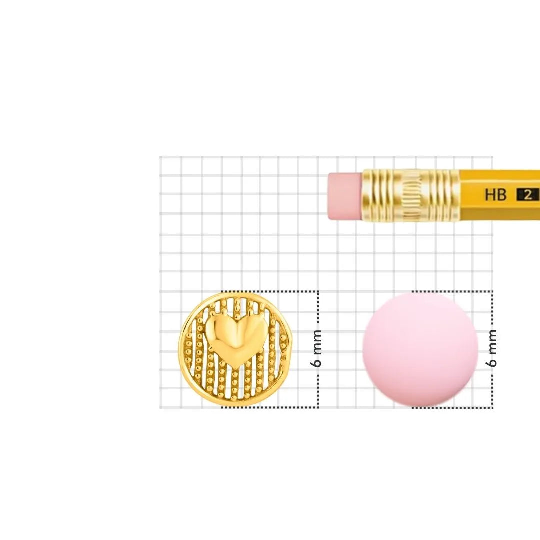 Gold nose pin displayed beside pencil for size comparison showing fine detailing and compact design