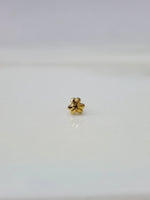 Front view of tiny floral 18K gold nose pin on a white background showing delicate craftsmanship