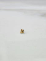 Side view of lightweight 18K gold nose pin on a white surface highlighting compact design and fine detailing