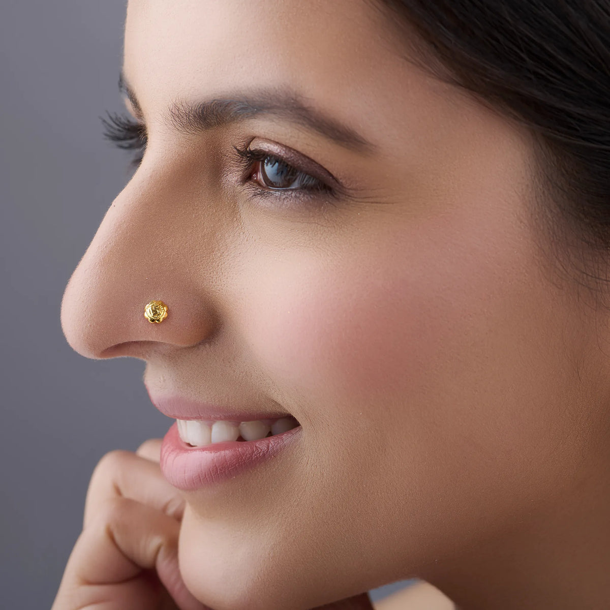 Woman wearing Swastik Bloom 18K Nose Pin Gold showcasing elegant ethnic look and minimalist jewellery style