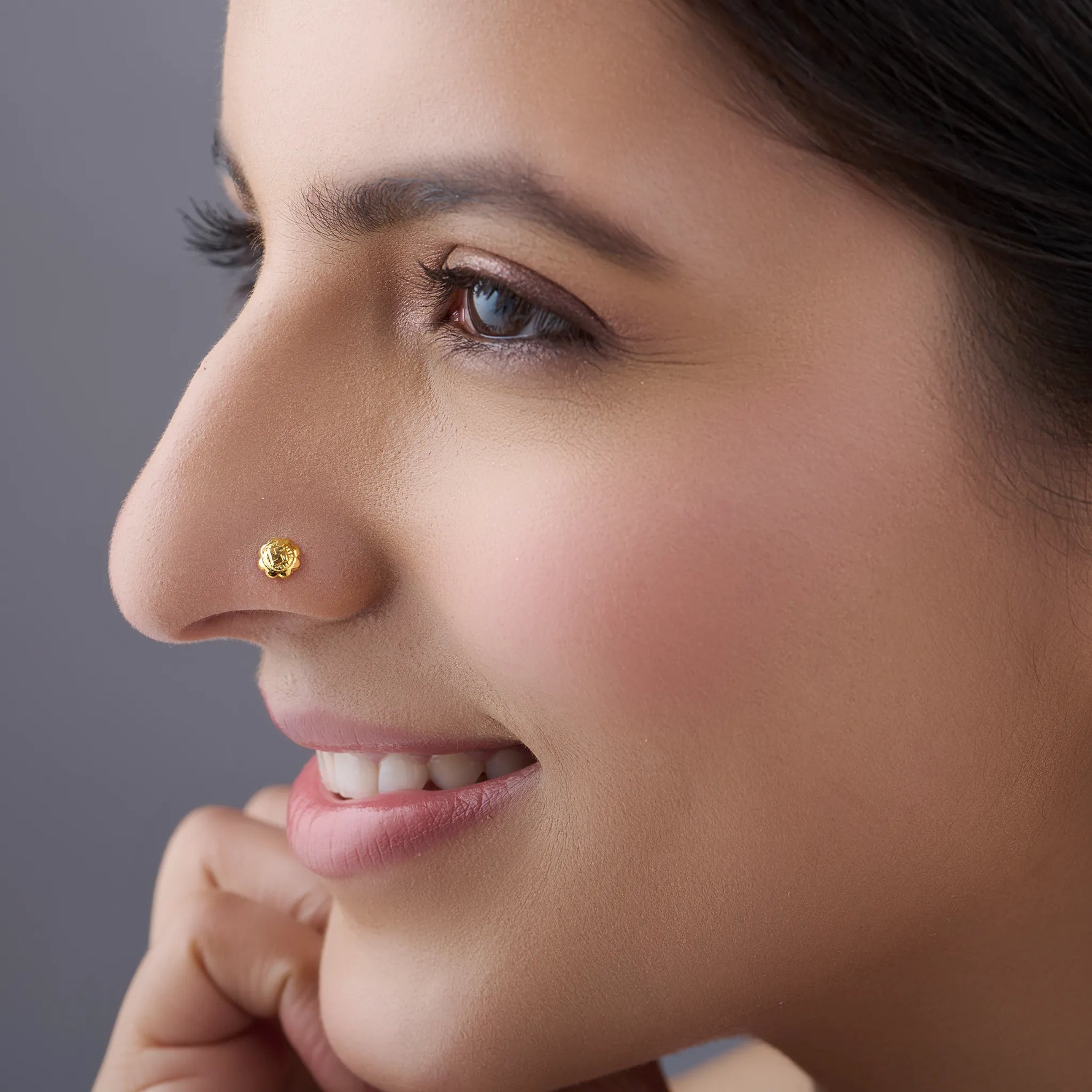 Woman wearing Swastik Bloom 18K Nose Pin Gold showcasing elegant ethnic look and minimalist jewellery style