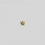 Side angle view of crescent gold nose pin showing curved minimalist form and fine finish