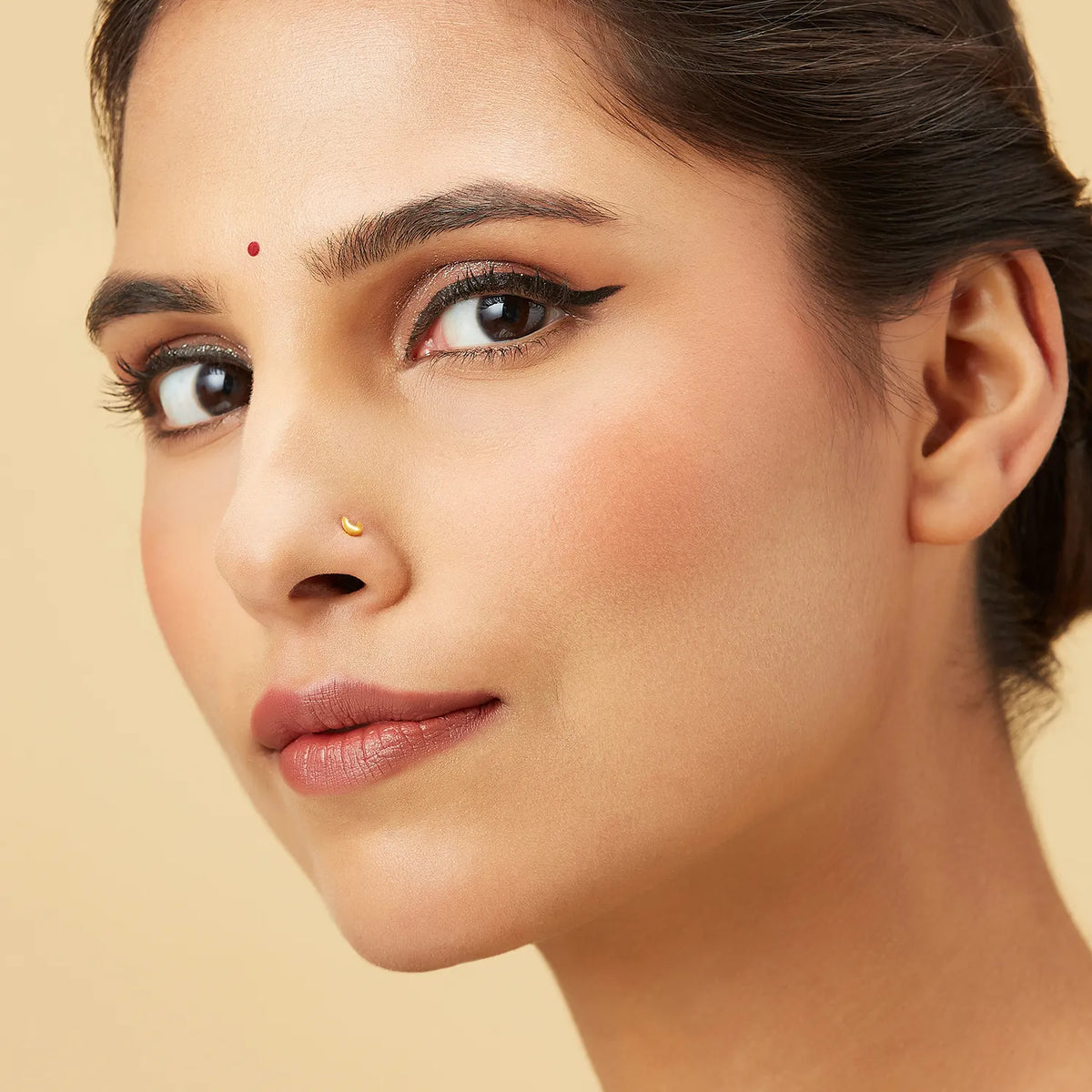 Model wearing crescent gold nose Model wearing crescent gold nose pin showing elegant fit and refined detailing