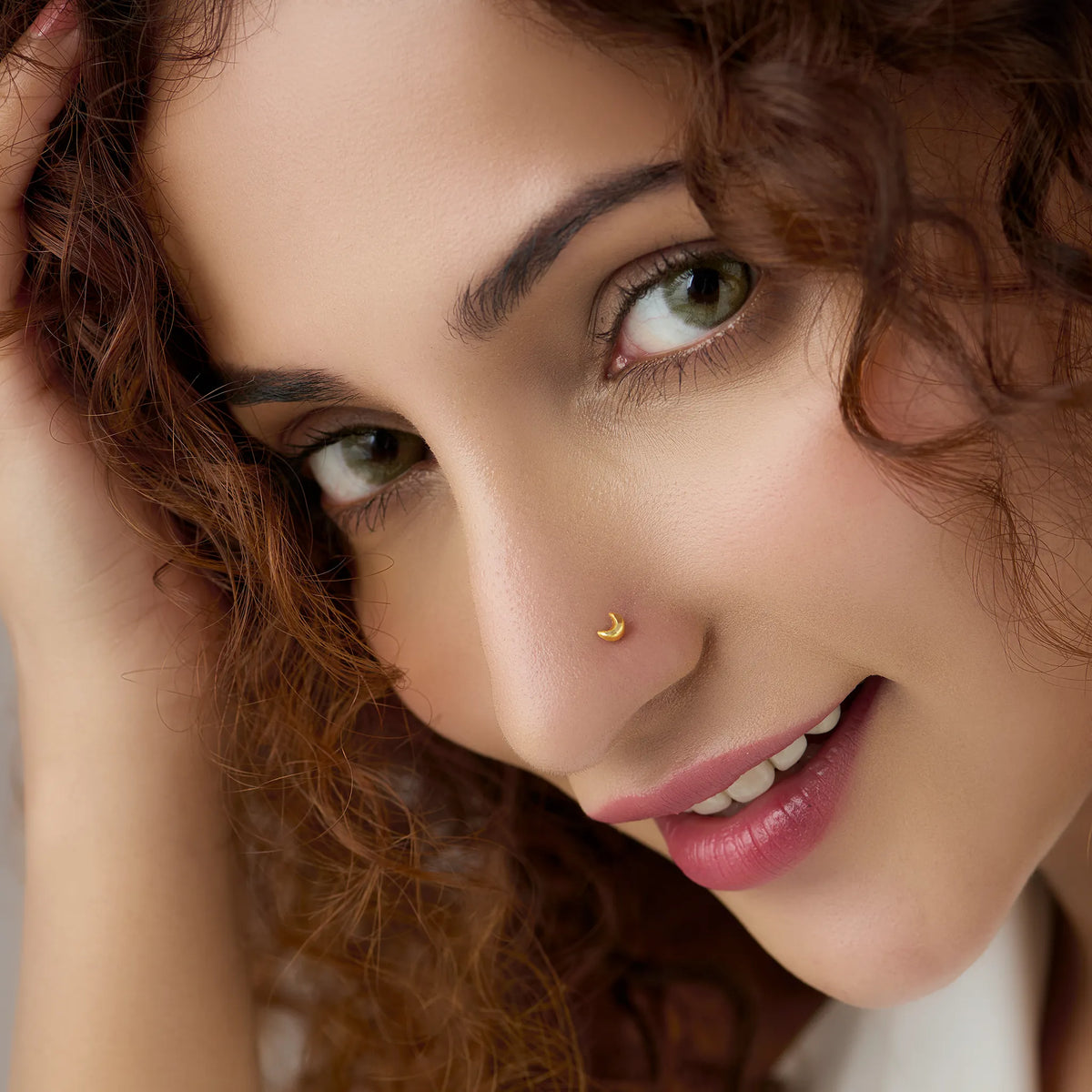 Woman wearing crescent moon gold nose pin highlighting chic and stylish everyday look