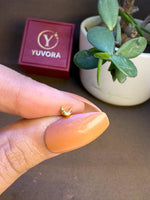 Crescent moon gold nose pin displayed on hand for real-life size comparison and clarity