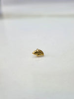 Side view of a tiny gold nose pin on a white surface highlighting its fine detailing
