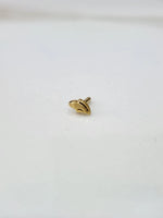 Front view of a small gold nose pin placed on a white background showing its compact size