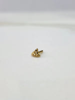 Small gold nose pin placed on a white background showing its compact size and clean detailing