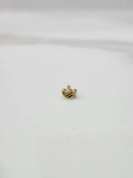 Tiny gold nose pin placed on a white background displaying its compact size and fine craftsmanship