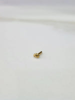 Front view of a small 18K gold nose pin placed on a white background showing its compact size and detailing