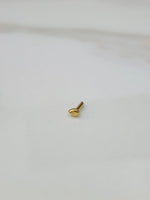Side angle view of small teardrop gold nose pin highlighting compact and refined design