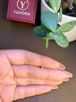 Gold teardrop nose pin displayed on hand for real size comparison and detailing clarity