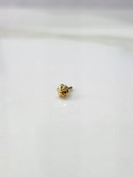 Front view of a small gold nose pin on a white background showing its compact lightweight design
