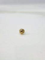 Side view of a lightweight gold nose pin on a white surface emphasizing fine craftsmanship